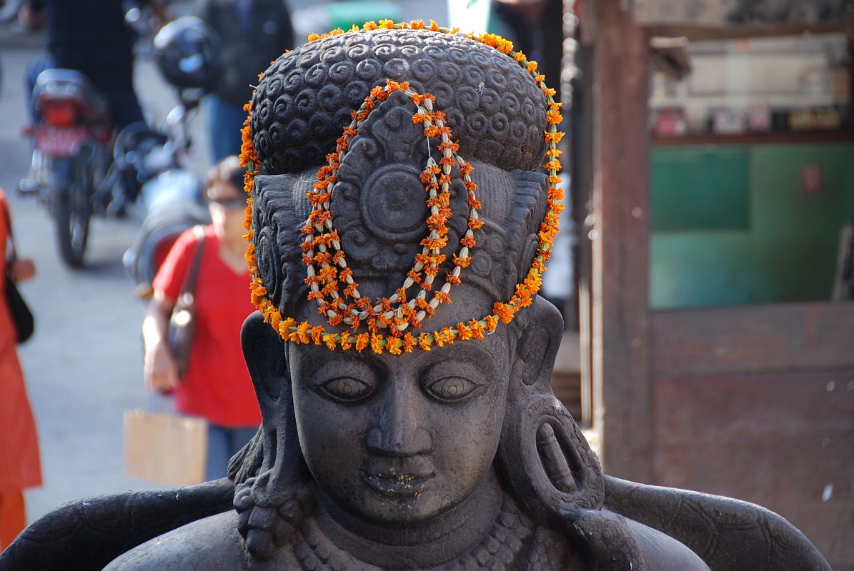 Kathmandu Durbar Square 03 02 Garuda Statue Close Up A garland adorns the head of Garuda in Kathmandu Durbar Square.